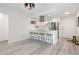 Well-lit kitchen with bar stool seating and stainless steel appliances with new hardwood floors at 955 Eudora St # 1606, Denver, CO 80220
