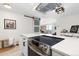 Modern kitchen with stainless steel appliances, a quartz countertop, and a stylish barn door in an open-concept space at 955 Eudora St # 1606, Denver, CO 80220