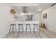 Modern kitchen featuring stainless steel appliances, white cabinetry, and stylish breakfast bar with seating at 955 Eudora St # 1606, Denver, CO 80220