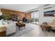 Spacious living room with brick wall accent, large windows, and access to a balcony, great for relaxing and entertaining at 955 Eudora St # 1606, Denver, CO 80220