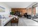 Inviting living room with brick accent wall, comfortable seating, and large windows for natural light and city views at 955 Eudora St # 1606, Denver, CO 80220