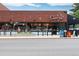 Street view of a neighborhood Snooze restaurant with red brick, big windows and some street parking at 955 Eudora St # 1606, Denver, CO 80220