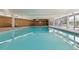 Indoor pool area with clear blue water, lounge chairs, and brick accents, perfect for relaxation at 955 Eudora St # 1606, Denver, CO 80220