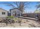 Beautifully landscaped backyard with a deck, barbecue grill, and rock garden. Ideal for relaxation at 1686 S Logan St, Denver, CO 80210
