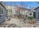 Secluded backyard featuring a stone patio, rock garden, wooden fence, and blooming tree at 1686 S Logan St, Denver, CO 80210