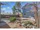 Expansive backyard featuring a stone water feature, mature trees, and patio seating at 1686 S Logan St, Denver, CO 80210