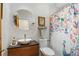 Stylish bathroom featuring a modern sink, colorful shower curtain, and neutral walls at 1686 S Logan St, Denver, CO 80210