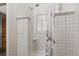 Modern tile shower with glass block window and shower curtain, offering a spa-like experience at 1686 S Logan St, Denver, CO 80210