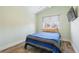 Bedroom featuring wood floors, a large window with blinds, and a neutral color scheme, creating a serene atmosphere at 1686 S Logan St, Denver, CO 80210