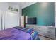 Bright bedroom offering wood floors and an oversized dresser for maximized storage at 1686 S Logan St, Denver, CO 80210