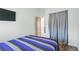 This bedroom features hardwood floors, a large window, and access to an open closet, optimizing space and functionality at 1686 S Logan St, Denver, CO 80210