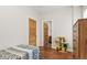 Bedroom featuring hardwood floors, neutral walls, and a view into an adjacent bathroom at 1686 S Logan St, Denver, CO 80210