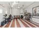 Finished bonus room space featuring a garage door, desk, seating area, and stylish striped floor at 1686 S Logan St, Denver, CO 80210