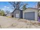 Three car garages located in the alleyway with white doors and grey siding at 1686 S Logan St, Denver, CO 80210