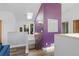 Bright hallway features stylish art, a skylight, and a striking purple accent wall with a glass block window at 1686 S Logan St, Denver, CO 80210