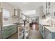 Charming kitchen featuring stainless steel appliances, white subway tiles, and a functional kitchen island at 1686 S Logan St, Denver, CO 80210