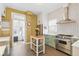 Bright kitchen with a stainless steel range, white subway tile backsplash, and a convenient kitchen island at 1686 S Logan St, Denver, CO 80210