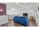 Bright living room with a comfortable blue sofa, hardwood floors, and natural light from the windows at 1686 S Logan St, Denver, CO 80210