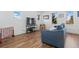 Inviting living room with wood floors, a comfortable blue sofa, and bright natural light from large windows at 1686 S Logan St, Denver, CO 80210