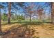 Local park with mature trees and open green spaces with a park bench and picnic tables at 1686 S Logan St, Denver, CO 80210