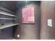 Unique storage space with custom shelving and dark walls, adding character and functionality at 1686 S Logan St, Denver, CO 80210