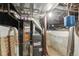 Basement utility room with furnace, water heater, and exposed ductwork for easy maintenance at 1686 S Logan St, Denver, CO 80210