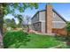 Lovely backyard with a gazebo, mature trees, a brick chimney and a well-kept lawn at 11076 Cotton Creek Dr, Westminster, CO 80031