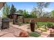Well-designed backyard with a gazebo, BBQ grill, decorative water feature, and stone patio at 11076 Cotton Creek Dr, Westminster, CO 80031
