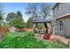 Well-manicured backyard with a gazebo, a storage shed, and lush green grass at 11076 Cotton Creek Dr, Westminster, CO 80031