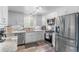 Well-lit kitchen featuring stainless steel appliances, granite countertops, and updated fixtures at 11076 Cotton Creek Dr, Westminster, CO 80031