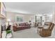 Spacious living room featuring a cozy fireplace, ample natural light, and comfortable seating at 11076 Cotton Creek Dr, Westminster, CO 80031