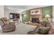 Comfortable living room featuring a brick fireplace and hardwood-style floors at 11076 Cotton Creek Dr, Westminster, CO 80031