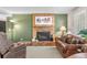 Comfortable living room featuring a brick fireplace and hardwood-style floors at 11076 Cotton Creek Dr, Westminster, CO 80031