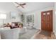 Cozy living room with a ceiling fan, ample natural light, and hardwood-style floors at 11076 Cotton Creek Dr, Westminster, CO 80031