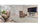 Inviting living room featuring plush seating, neutral tones, and seamless flow to the adjacent kitchen at 11076 Cotton Creek Dr, Westminster, CO 80031