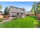 Spacious backyard featuring lush lawn, patio with gazebo, and outdoor grill perfect for entertaining guests at 11076 Cotton Creek Dr, Westminster, CO 80031