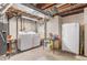 Unfinished basement area showcases the laundry hook ups and an additional refrigerator at 11076 Cotton Creek Dr, Westminster, CO 80031