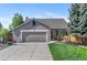 Charming single-story home with a two-car garage, well-manicured lawn, and inviting front porch at 11076 Cotton Creek Dr, Westminster, CO 80031
