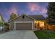 Charming single-story home with a two-car garage, well-manicured lawn, and inviting front porch at 11076 Cotton Creek Dr, Westminster, CO 80031
