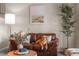 Cozy living room with a leather sofa, neutral decor, and ample natural light at 11076 Cotton Creek Dr, Westminster, CO 80031