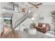Bright living room featuring a vaulted ceiling, modern staircase, and stylish furnishings at 11076 Cotton Creek Dr, Westminster, CO 80031