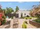 Private backyard with a lush garden, outdoor seating and a detached two car garage at 2990 Osceola St, Denver, CO 80212