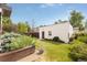 Grassy backyard featuring well-maintained landscaping and a detached two car garage at 2990 Osceola St, Denver, CO 80212