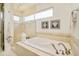 Bright bathroom with a soaking tub, walk-in shower, and stylish fixtures at 2990 Osceola St, Denver, CO 80212