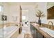 Full bathroom with a soaking tub and vanity with modern fixtures at 2990 Osceola St, Denver, CO 80212