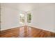Bright bedroom featuring hardwood floors, modern trim, and an abundance of natural light from the large windows at 2990 Osceola St, Denver, CO 80212