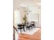 Elegant dining room featuring a modern chandelier, hardwood floors, and large picture window at 2990 Osceola St, Denver, CO 80212