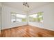 A sunlit room with hardwood floors and lots of windows at 2990 Osceola St, Denver, CO 80212
