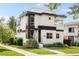 Modern two-story home featuring sleek architectural lines, a beautiful front yard, and abundant natural light at 2990 Osceola St, Denver, CO 80212