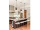 Stylish kitchen island featuring seating and modern pendants with stainless steel appliances at 2990 Osceola St, Denver, CO 80212